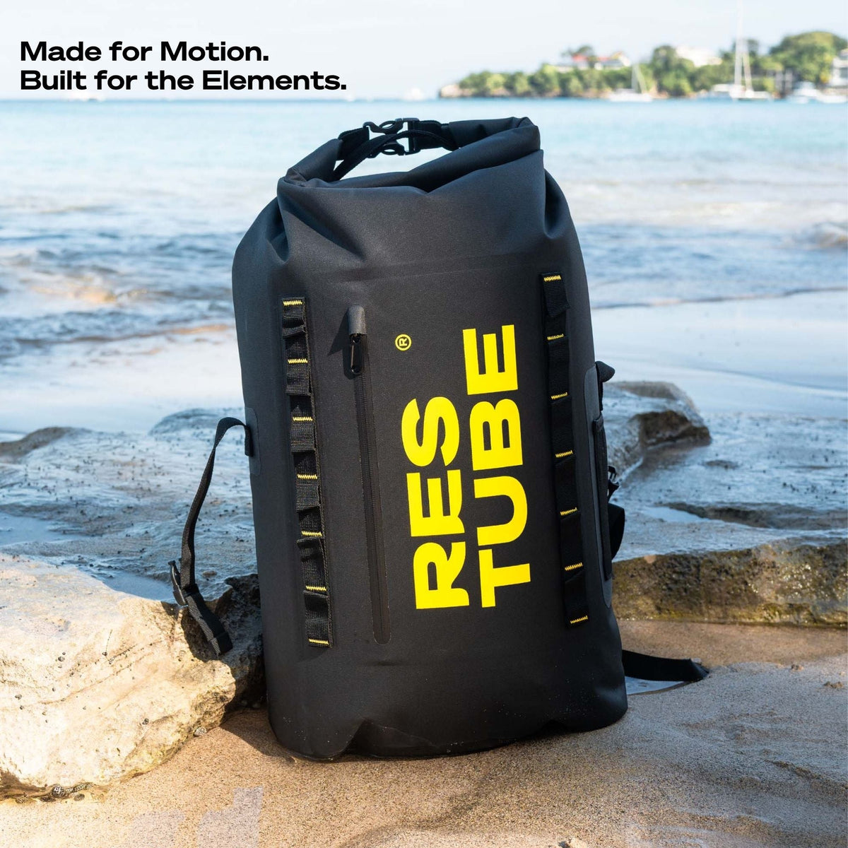 RESTUBE COAST 25L black backpack on a rocky beach with yellow RESTUBE branding - urban outdoor Philippines