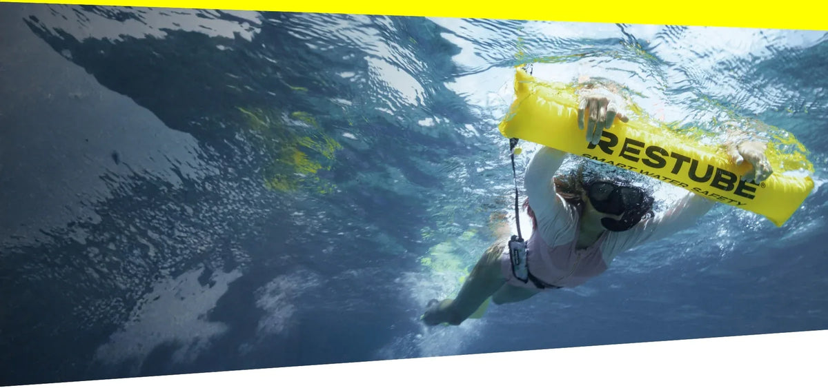 Snorkeler with RESTUBE swim buoy in clear tropical water - Snorkeling Philippines