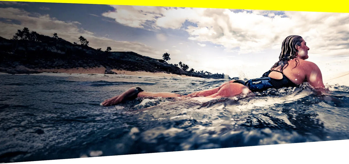 Surfer with RESTUBE ACTIVE safety buoy - Surfing water safety Philippines