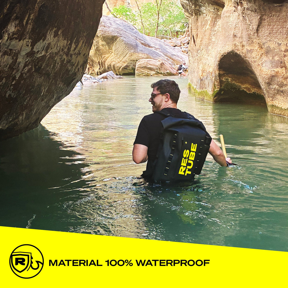 Man wading through canyon river wearing RESTUBE COAST 25L black backpack - water-resistant material Philippines