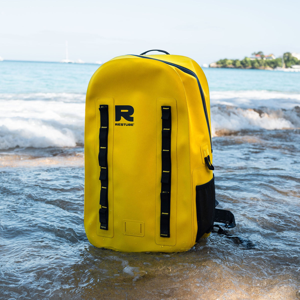 RESTUBE OCEAN 28L yellow waterproof backpack standing in the ocean - designed for water adventures Philippines